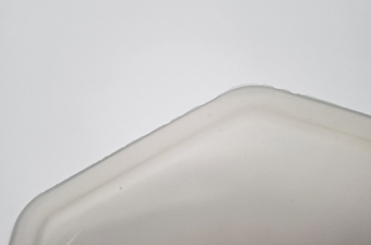 Close-up of silicone placemat for cat dinnerware with excess, slightly frayed lower edge as a minor manufacturing defect