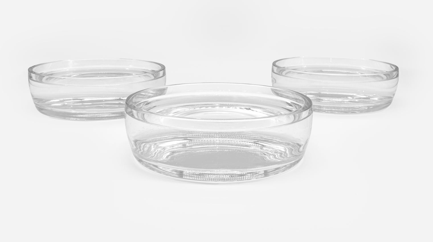 3 drinking bowls for cats, filled almost to the brim – one in the middle at the front, two offset to the left and right at the back