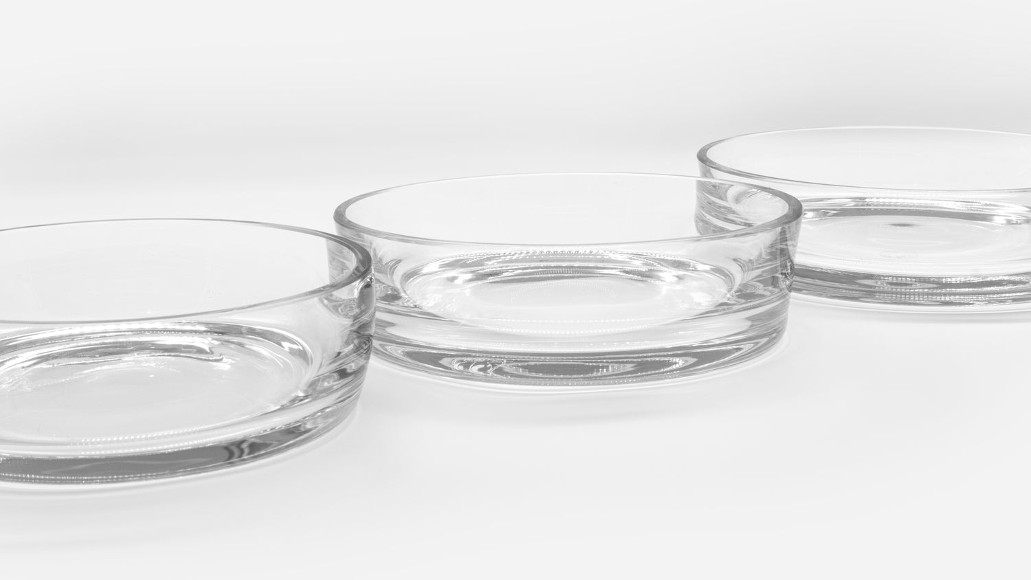 3 drinking bowls in 3 different sizes for cats, slightly offset in perspective behind and next to each other